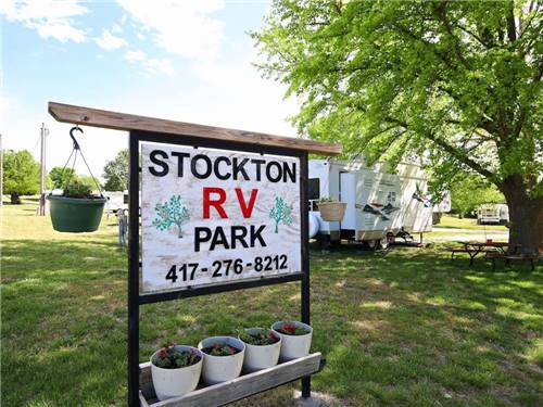 Sign of the park name with flower pots underneath