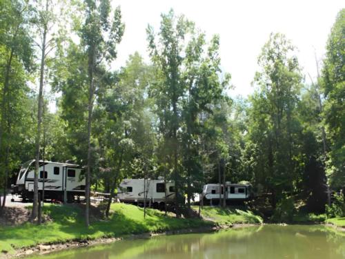 Parked trailers at site Little River RV Park & Campground