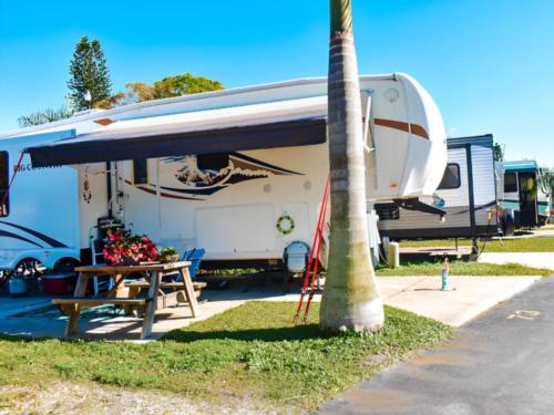 Parked trailer at site Tropical Gardens RV Park