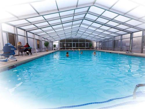 People enjoying the indoor swimming pool at PREFERRED RV RESORT