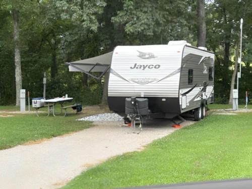 Parked trailer next to panic table at Ozark Outdoors/Riverfront Resort