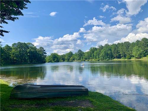 A boat upside down along the water's edge at WENDY OAKS RV RESORT