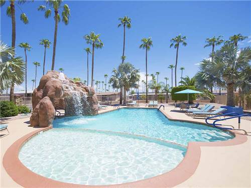 The pool with a waterfall at PALM GARDENS MHC & RV PARK