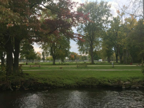 View of park with tables and creek at Veterans Memorial Park (Village Park)