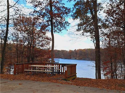 A picnic bench on a platform overlooking the lake