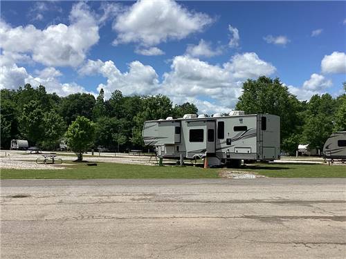 Fifth wheel parked at a gravel site at Camping World-Campground of Oxford