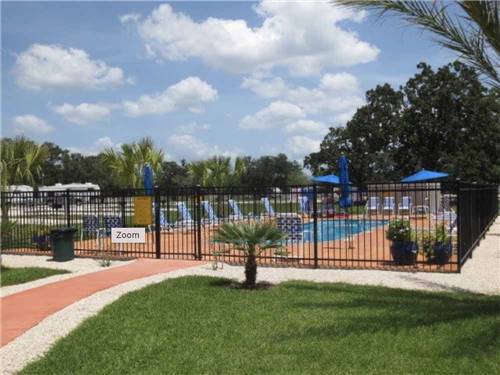 View of the fenced in swimming pool at VICTORIA COLETO LAKE RV RESORT