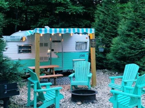 Vintage trailers and matching chairs at Camp Leconte Luxury Outdoor Resort