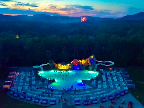 A view of the swimming pool lit up at night at MOOSE HILLOCK CAMPING RESORT NY