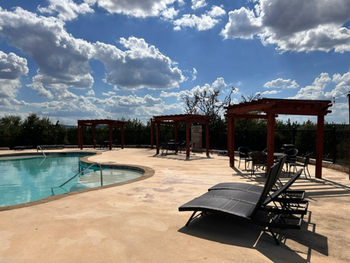 Seating around the pool at Antler Oaks Lodge and RV Resort