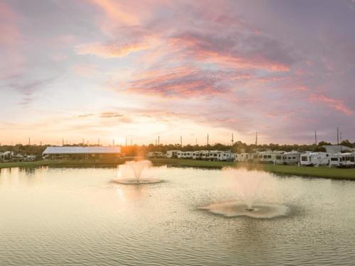 RV sites near a pond at sunset