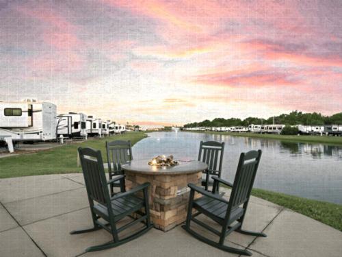 Community firepit, RVs by the water at Highway 6 RV Resort