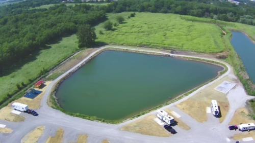 RV's parked next to lake at Bell RV Village