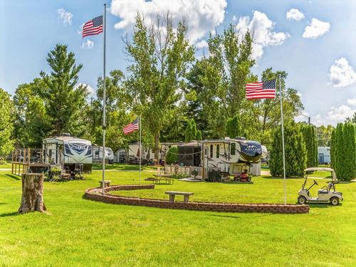 rVs parked in grassy sites at Northwoods RV Resort