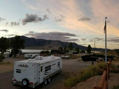 RV sites with lake in the distance at Bridgeport Reservoir Marine and Campground