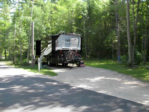 Parked RV at site Torch Lake Campground & RV Park
