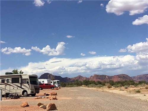 A line of gravel RV sites with mountains in the background at KAIBAB PAIUTE TRIBAL RV PARK