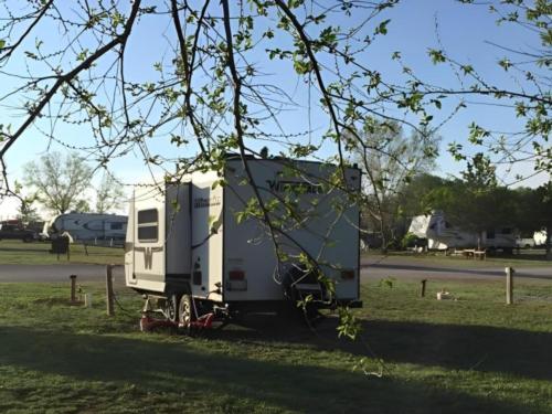 Parked RV trailer at site Bobcat Creek RV Park