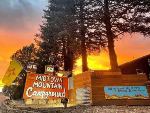 Sunset and pine trees at Midtown Mountain Campground & RV Park