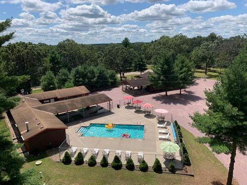Aerial shot of wooded area and pool at Dells Camping Resort