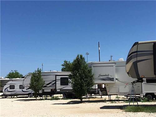 A row of trailers in gravel sites at SUNDANCE RV PARK
