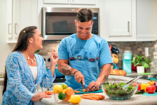 A mom and dad cooking dinner