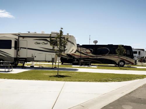 Parked trailer and RV at site Camp Cedar