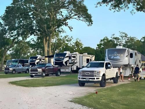 Travel trailers and trucks in paved sites at St. Ives RV Resort