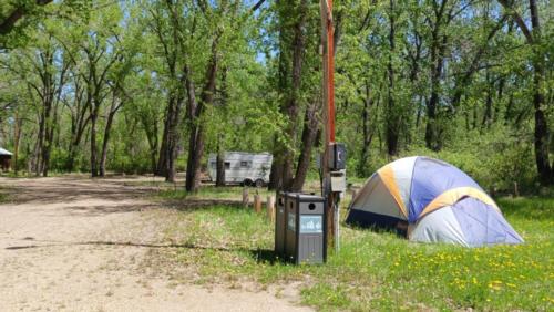 A tent and trailer at sites