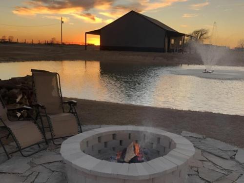 A fire pit with pond in the background