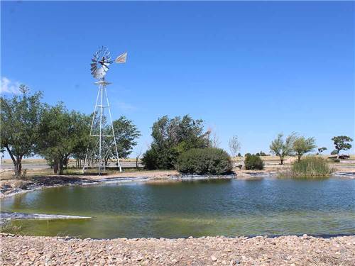 The windmill and pond at COYOTE KEETH'S RV PARK