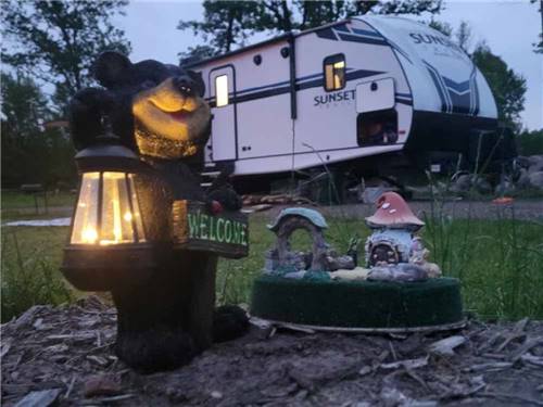 A bear statue next to a RV site at RINGLER FAMILY CAMPGROUND