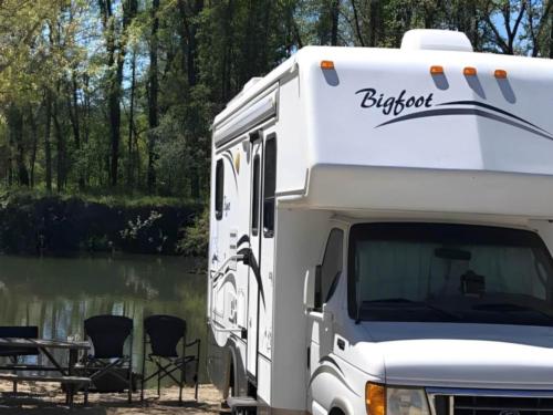 RV parked near lake at site Clear Lake Campground