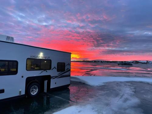 Camper during sunrise at Sleeping Buffalo Hot Springs & Resort