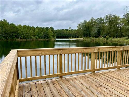 A wooden deck on the water at MIDPOINT I-95 RV PARK