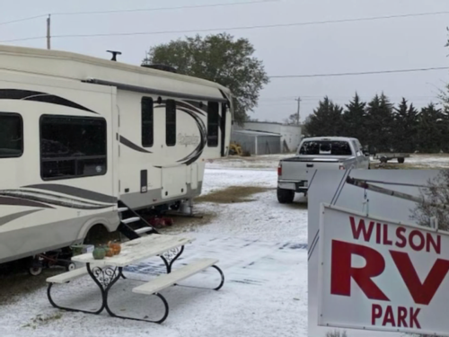 Snowy RV site with picnic table at Wilson RV Park