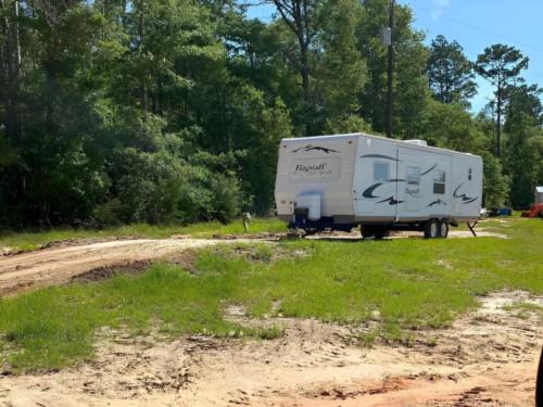Parked travel trailer at Yall Come Back RV Park