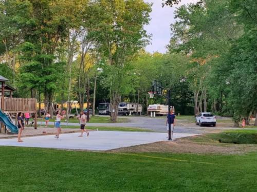 Playground, basketball court and grassy area at Pipestem RV Park and Campground