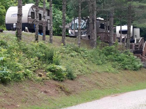 Parked RV and trailers at site Black Bear Resort