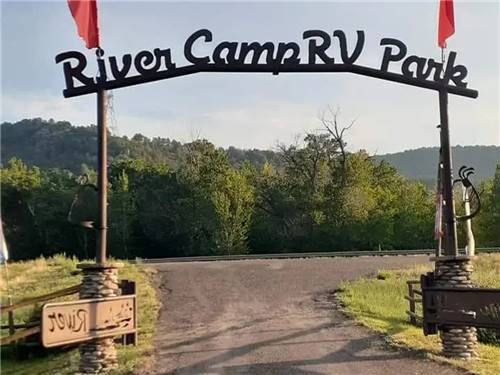 "River Camp RV Park" arch leading into RV Park