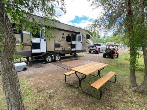 Camper with picnic table at River Camp RV Park