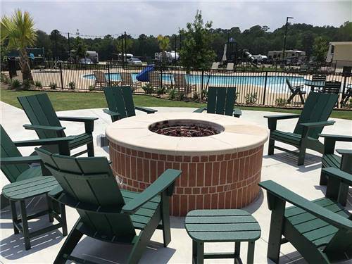 Cement fire pit with lounge chairs at LAUREL SPRINGS RV RESORT