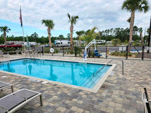 The fenced in swimming pool at SANTA FE PALMS RV RESORT