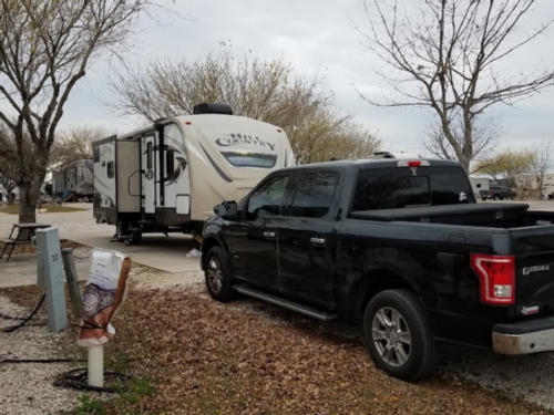 Black truck and trailer in site at Canyon Trail RV Resort