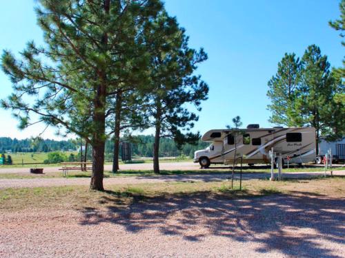 RV in a gravel site at PINE HAVEN VENUE & LODGING