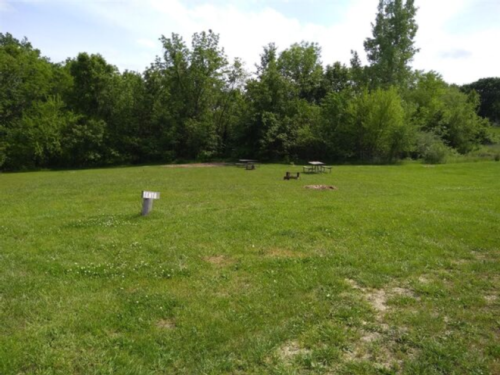 Grass site with picnic table at Powell's Creekside Haven