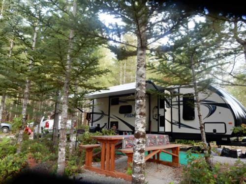 Trailer in treed site with picnic table