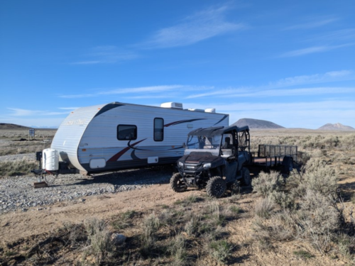 Trailer and ATV in gravel site at Atomic City RV Park