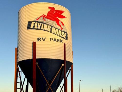 The water tower with the park name on it at FLYING HORSE RV PARK