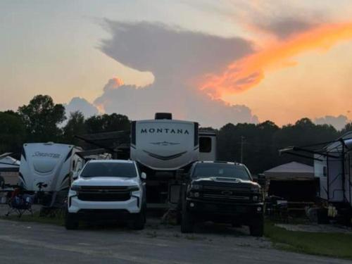 RVs parked in sites at sunset at THE LANDING STRIP CAMPGROUND